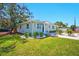 Inviting single-story home with a lush green lawn, complemented by vibrant landscaping and a welcoming entrance at 5030 9Th S Ave, Gulfport, FL 33707