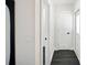 Hallway with dark wood floors and white doors, showcasing clean lines and modern design at 5030 9Th S Ave, Gulfport, FL 33707