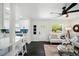 Bright and airy living room with a sofa, decorative accents, and open layout, seamlessly flowing into the adjacent kitchen at 5030 9Th S Ave, Gulfport, FL 33707