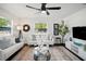 Contemporary living room with sleek furniture, stylish decor, dark floors, and a large window for ample light at 5030 9Th S Ave, Gulfport, FL 33707