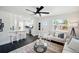 Modern living room with a sofa, decorative accents, and a view into the kitchen, creating a welcoming and stylish atmosphere at 5030 9Th S Ave, Gulfport, FL 33707