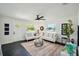 Bright living room featuring modern decor, white walls, dark floors, and abundant natural light from large windows at 5030 9Th S Ave, Gulfport, FL 33707