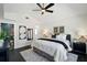 Spacious main bedroom with a ceiling fan, modern decor, and an ensuite bathroom at 5030 9Th S Ave, Gulfport, FL 33707