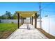 A backyard pergola with a stone tile path and a privacy fence, offering a serene and stylish outdoor space at 5030 9Th S Ave, Gulfport, FL 33707