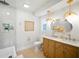 Bright bathroom with a double sink vanity, stylish lighting, and a glass-enclosed shower at 5647 110Th Way, Seminole, FL 33772