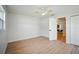 Bedroom with light wood floors, a ceiling fan and closet. Entryway leading to living spaces at 5647 110Th Way, Seminole, FL 33772