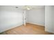 Simple bedroom showcasing light wood floors, white walls, and a ceiling fan at 5647 110Th Way, Seminole, FL 33772