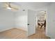 Bedroom with light wood floors, white walls, and entryway leading to dining area at 5647 110Th Way, Seminole, FL 33772