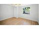 Bedroom with light wood floors, white walls, a ceiling fan and a large window at 5647 110Th Way, Seminole, FL 33772