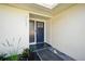 Inviting front entry with gray tiles and a contemporary navy blue front door at 5647 110Th Way, Seminole, FL 33772