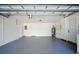 Clean, organized garage with painted floor, utility connections, and door to house at 5647 110Th Way, Seminole, FL 33772