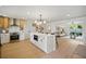 Open-concept kitchen with island, breakfast bar, stainless oven, and views into the living room at 5647 110Th Way, Seminole, FL 33772