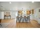 Open floor plan showcasing kitchen island with seating, sleek cabinetry, and modern decor at 5647 110Th Way, Seminole, FL 33772
