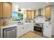 Bright kitchen features stainless appliances, stone countertops, and a window overlooking the neighborhood at 5647 110Th Way, Seminole, FL 33772