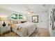 Bright main bedroom features a large window, ceiling fan, neutral paint, and closet at 5647 110Th Way, Seminole, FL 33772