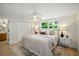 Bright main bedroom features a large window, ceiling fan, neutral paint, and closet at 5647 110Th Way, Seminole, FL 33772