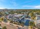 Beautiful aerial view of homes, buildings, and beach under a clear, sunny sky and palm trees at 5659-5657 Shore S Blvd, Gulfport, FL 33707