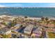 Beautiful aerial view of homes near a picturesque beach with sailboats on the water and palm tree lined street at 5659-5657 Shore S Blvd, Gulfport, FL 33707