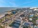 Great aerial view of homes, buildings, and beach under a clear, sunny sky, and palm tree lined street at 5659-5657 Shore S Blvd, Gulfport, FL 33707