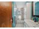 Sleek bathroom with walk-in shower, modern fixtures, and stylish blue walls at 5659-5657 Shore S Blvd, Gulfport, FL 33707