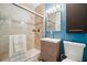 Updated bathroom featuring a glass shower with decorative tile and vanity at 5659-5657 Shore S Blvd, Gulfport, FL 33707