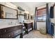 Bathroom with dual vanities, modern fixtures, and linen storage at 5659-5657 Shore S Blvd, Gulfport, FL 33707