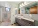 Well-lit bathroom with a modern vanity, stylish fixtures, and a glass-enclosed shower at 5659-5657 Shore S Blvd, Gulfport, FL 33707