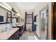 Bright bathroom featuring double vanity, shower, window and natural light at 5659-5657 Shore S Blvd, Gulfport, FL 33707