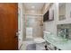 Bathroom featuring a glass bowl sink, a sliding glass shower door and custom tile at 5659-5657 Shore S Blvd, Gulfport, FL 33707