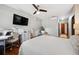 Bright bedroom with modern fan, desk, and chair, offering a comfortable workspace at 5659-5657 Shore S Blvd, Gulfport, FL 33707