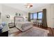 Bedroom with hardwood floors, large window and a sitting area at 5659-5657 Shore S Blvd, Gulfport, FL 33707