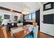 Dining area with wood floors, stylish decor, modern lighting, and views of the contemporary kitchen at 5659-5657 Shore S Blvd, Gulfport, FL 33707
