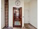 Hallway with an elevator entrance featuring wood-trimmed elevator doors and travertine tile flooring at 5659-5657 Shore S Blvd, Gulfport, FL 33707