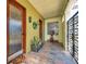 Charming entrance with a decorative door, gated entry, potted plants and stone flooring at 5659-5657 Shore S Blvd, Gulfport, FL 33707