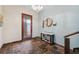 Stylish home entrance with stone tiled floor, wood door, console table and nautical decor at 5659-5657 Shore S Blvd, Gulfport, FL 33707