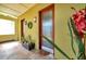 Welcoming home entrance with tiled floor, frosted-glass front door and tropical-themed decorations at 5659-5657 Shore S Blvd, Gulfport, FL 33707