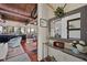 Open entryway with a decorative mirror and a peek into the Gathering room and kitchen at 5659-5657 Shore S Blvd, Gulfport, FL 33707