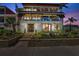 Stunning three-story home with lush landscaping, gated entry, and inviting outdoor living spaces at 5659-5657 Shore S Blvd, Gulfport, FL 33707
