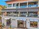 Multi-level home with glass balconies, offering stunning views and outdoor living spaces at 5659-5657 Shore S Blvd, Gulfport, FL 33707