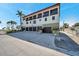Spacious home exterior featuring a large driveway with ample parking, and a convenient garage at 5659-5657 Shore S Blvd, Gulfport, FL 33707