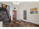 View of tiled foyer with stairs and chandelier lighting at 5659-5657 Shore S Blvd, Gulfport, FL 33707