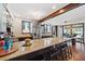 Bright eat-in kitchen with a large granite-top island with seating, a stainless fridge and hardwood floors at 5659-5657 Shore S Blvd, Gulfport, FL 33707