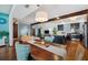 Bright open-concept living area with hardwood floors, modern lighting, and an island with granite countertop at 5659-5657 Shore S Blvd, Gulfport, FL 33707