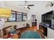 A cozy living room with a fireplace, many windows and a ceiling fan is perfect for relaxing after a long day at 5659-5657 Shore S Blvd, Gulfport, FL 33707