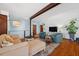 Cozy living area with wood floors, comfortable seating, a large TV and access to other living spaces at 5659-5657 Shore S Blvd, Gulfport, FL 33707