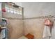 Walk-in shower featuring decorative tile, a glass block window and a built-in seat at 5659-5657 Shore S Blvd, Gulfport, FL 33707