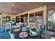 Relaxing sun room with outdoor dining area, ocean views and comfortable seating arrangements at 5659-5657 Shore S Blvd, Gulfport, FL 33707