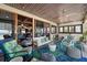 Spacious sun room featuring a comfortable seating arrangement with ocean view and access to the main house at 5659-5657 Shore S Blvd, Gulfport, FL 33707