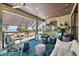 Bright sun room with views of the ocean, comfortable seating, stylish decor and ceiling fan at 5659-5657 Shore S Blvd, Gulfport, FL 33707