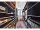 Custom walk-in closet with dark shelving, lighting, and floor to ceiling storage at 5659-5657 Shore S Blvd, Gulfport, FL 33707